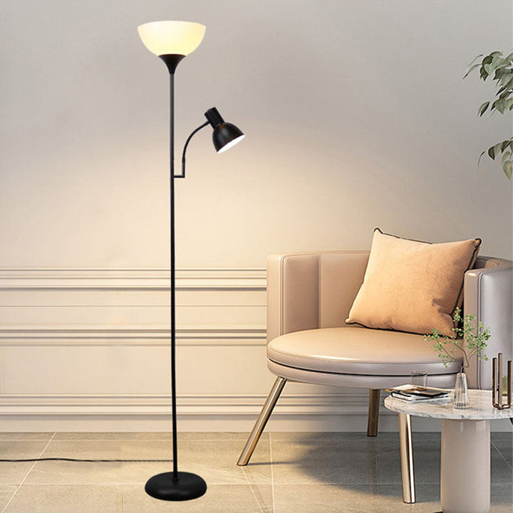 Weiße Stehlampe mit Leselicht vor blauer Wand und beige gepolstertem Stuhl