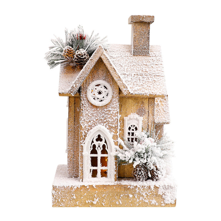 Beleuchtetes Weihnachts-Holzhaus mit Schneelandschaft