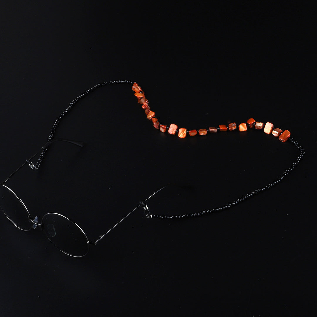 Perlenbrillenhalter mit natürlichen Muschelakzenten Karnz