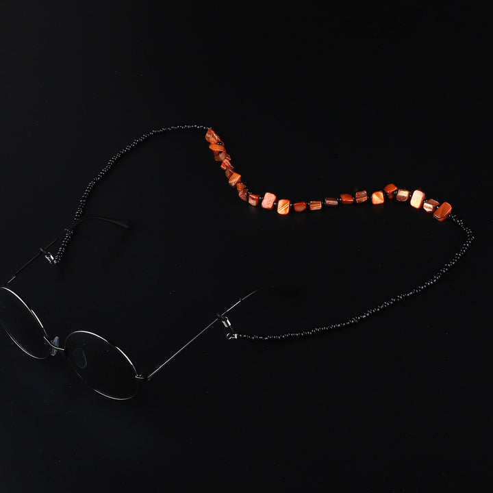 Perlenbrillenhalter mit natürlichen Muschelakzenten Karnz