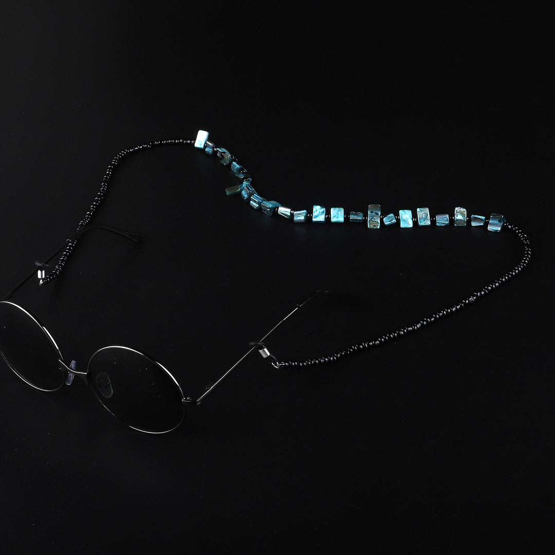 Perlenbrillenhalter mit natürlichen Muschelakzenten Karnz