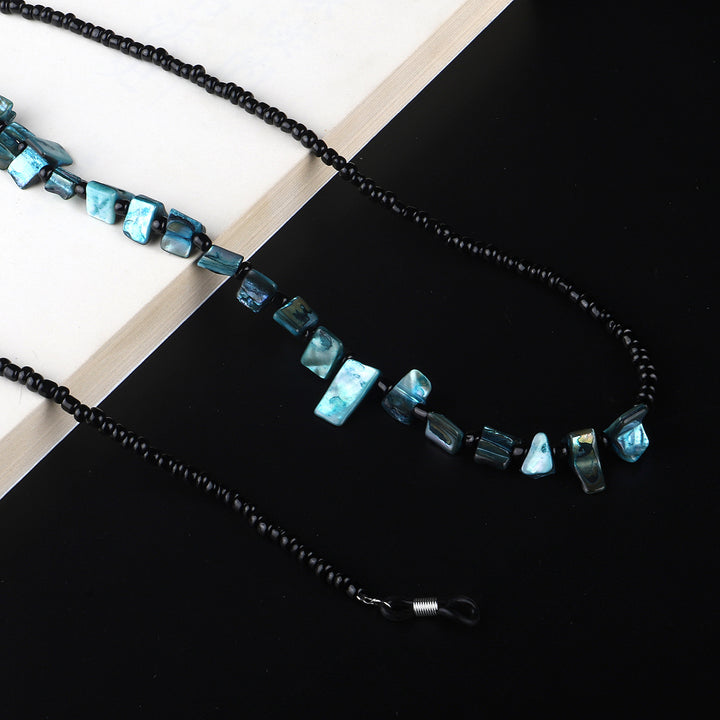 Perlenbrillenhalter mit natürlichen Muschelakzenten Karnz