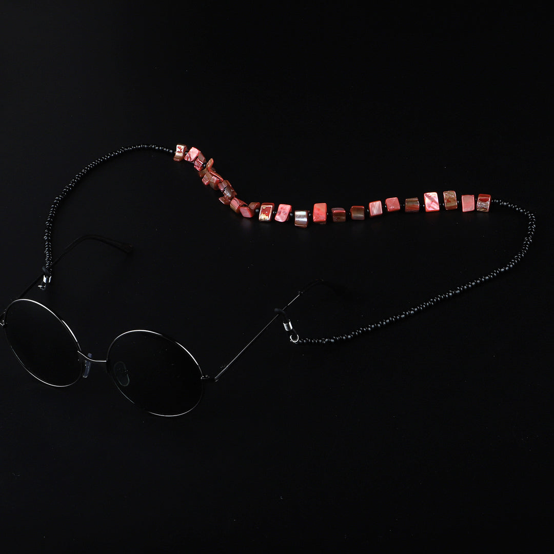 Perlenbrillenhalter mit natürlichen Muschelakzenten Karnz