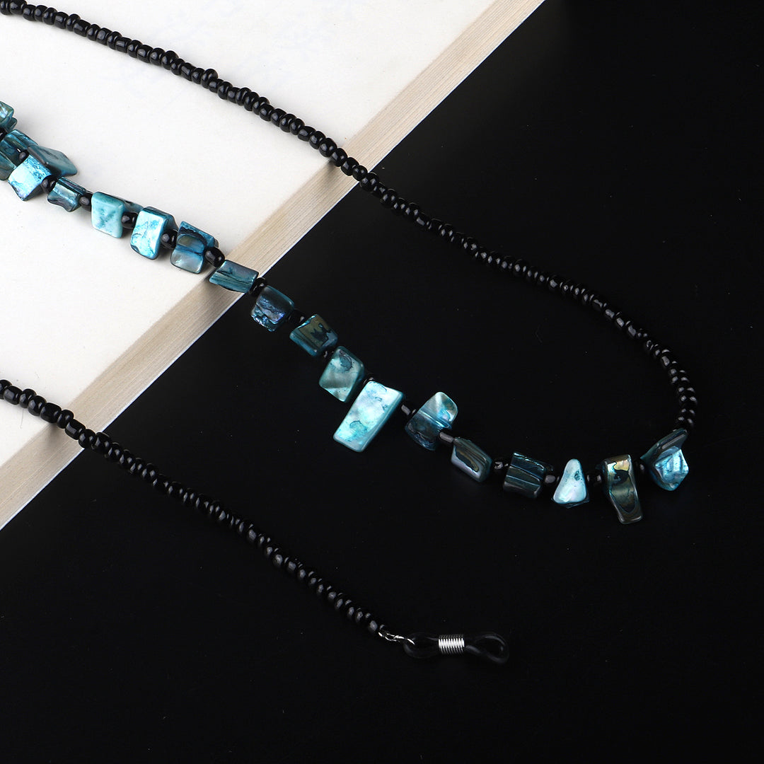Perlenbrillenhalter mit natürlichen Muschelakzenten Karnz