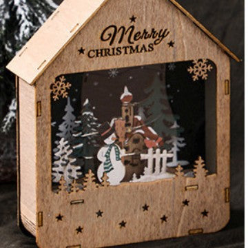 Beleuchtetes Holzhaus mit LED-Weihnachtsdeko