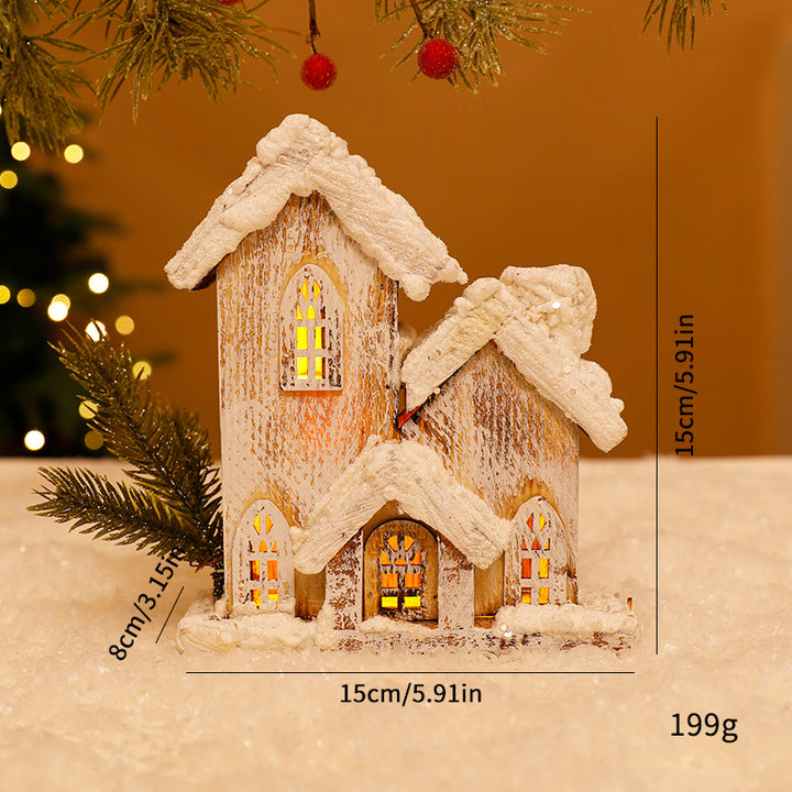 Beleuchtetes Weihnachts-Holzhaus mit Schneelandschaft