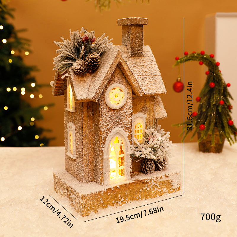 Beleuchtetes Weihnachts-Holzhaus mit Schneelandschaft