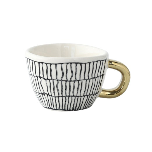 Tasse mit abstraktem geometrischen Muster und goldenem Henkel