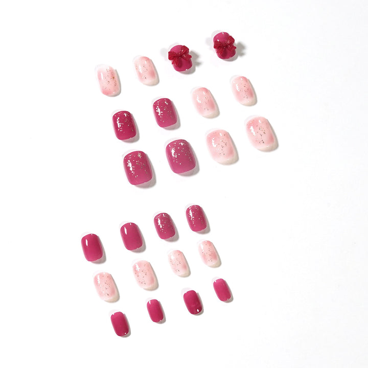 Künstliche Nagelkunst mit Glitzerverzierungen und niedlichem Schleifenmotiv Karnz
