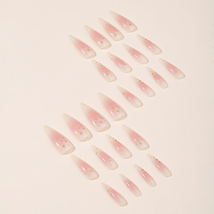Kunstnagelset mit zartem Ombre-Design und glamourösen Sternakzenten Karnz