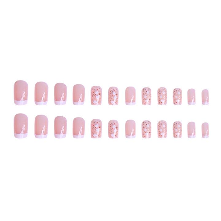 Kunstnagelset mit floralen Verzierungen und elegantem französischen Design Karnz
