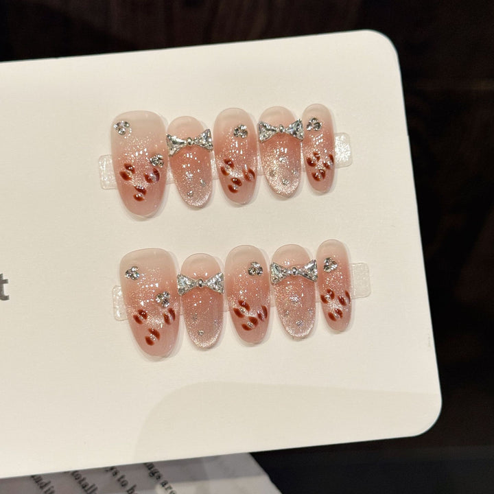 Dekoratives Press-On Nagelkunst-Set mit glitzernden Schleifenakzenten