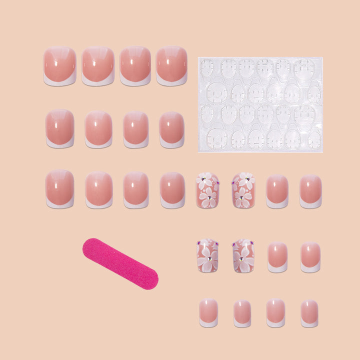 Kunstnagelset mit elegantem French Design und floralen Akzenten Karnz