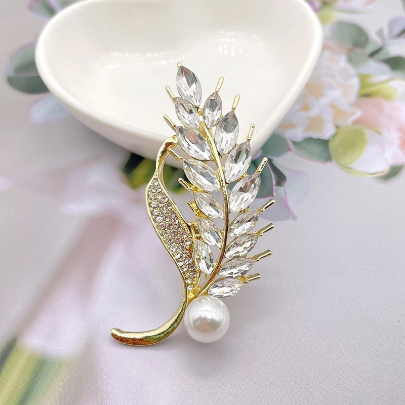 Elegante Brosche mit Glitzerstein und Perle Karnz