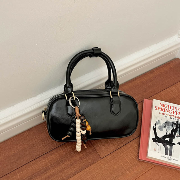 Vintage-inspirierte glänzende Handtasche
