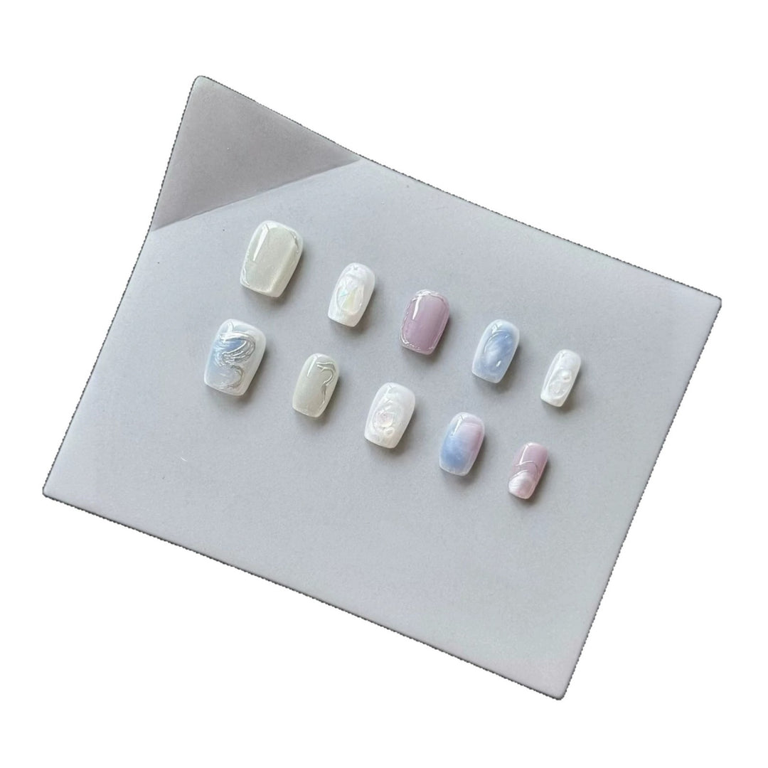 Künstlerisches Press-On Nagelset mit perlmuttartigen und marmorierten Designs