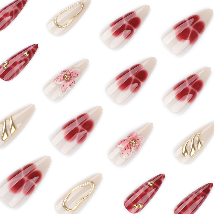 Kunstvolle Stiletto-Nägel mit eleganten Blumendesigns und Glitzerakzenten Karnz