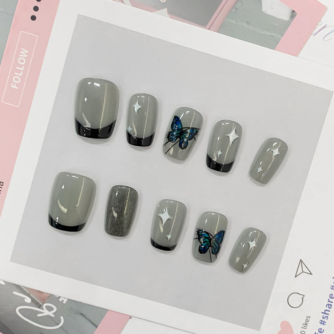 Kunstvolle Nagelspitzen mit Schmetterlings-Motiven Karnz