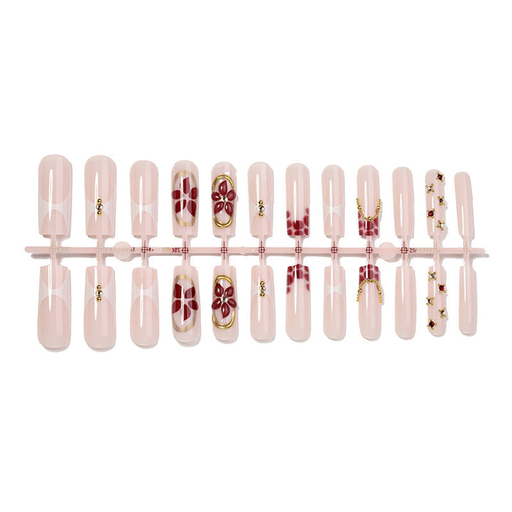 Kunstnagelset mit floralen Verzierungen und eleganten Akzenten Karnz