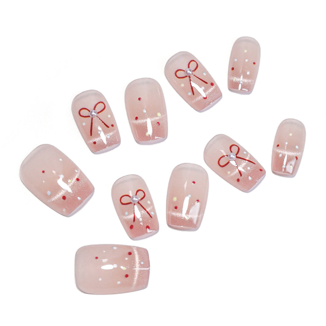 Künstliche Nagelkunst mit eleganten Schleifen und Glitzerakzenten Karnz