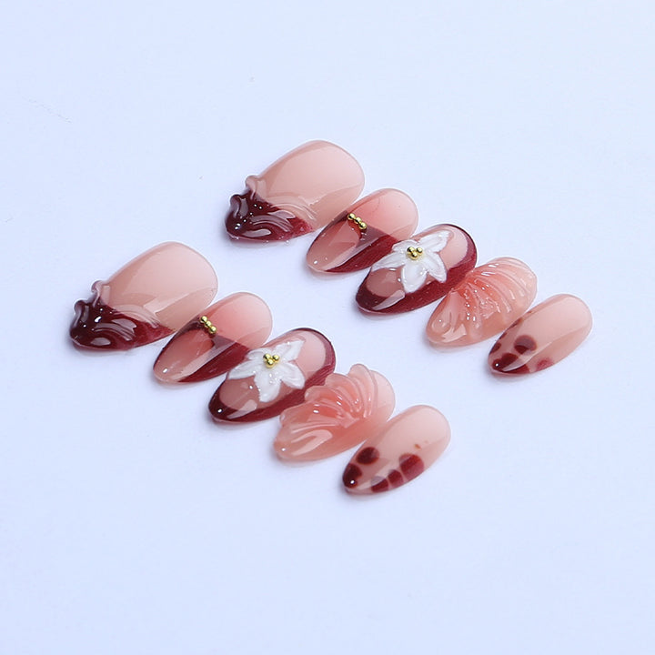 Kunstnagelset mit floralen 3D-Applikationen und eleganter Farbverlaufsgestaltung Karnz