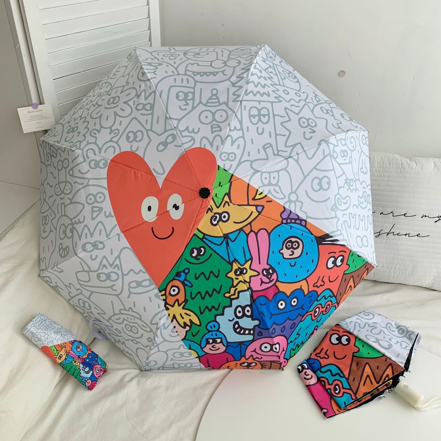 Damen Faltregenschirm mit bunten Comic-Motiven Karnz