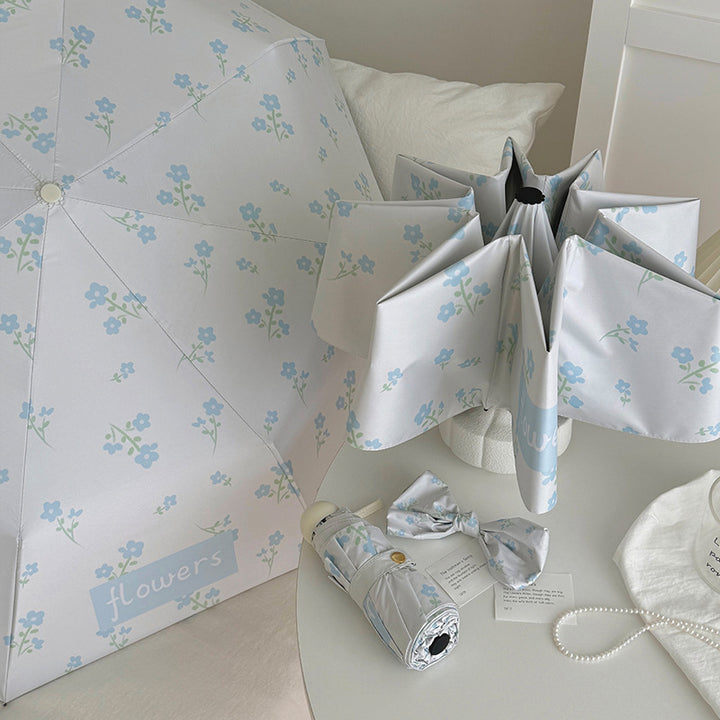 Damen Faltender Regenschirm mit stilvollem Blumendesign Karnz