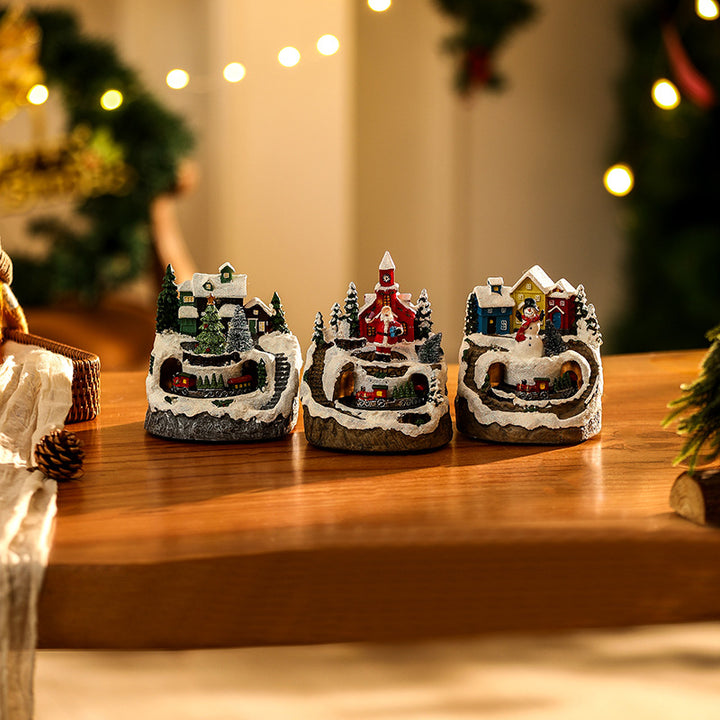 Beleuchtete Weihnachtsdorf-Szene mit Schneemann Karnz