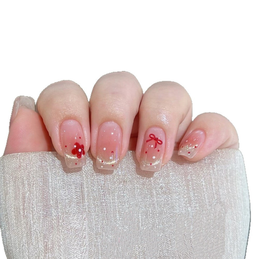 Dekoratives Press-On Nagelset mit floralen und Schleifenakzenten Karnz
