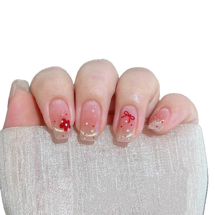 Dekoratives Press-On Nagelset mit floralen und Schleifenakzenten Karnz