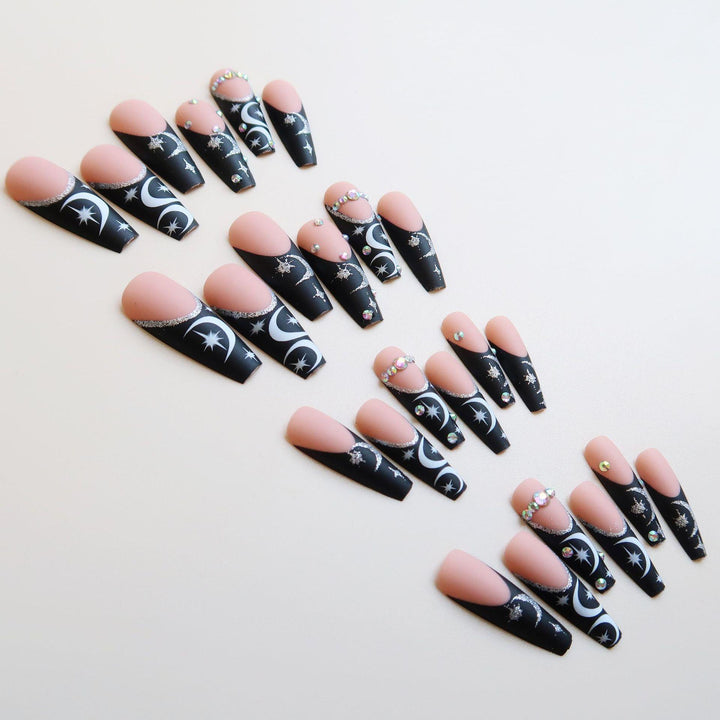 Künstlerisches langes Stiletto Press-On Nagelset mit Mond- und Sternmustern