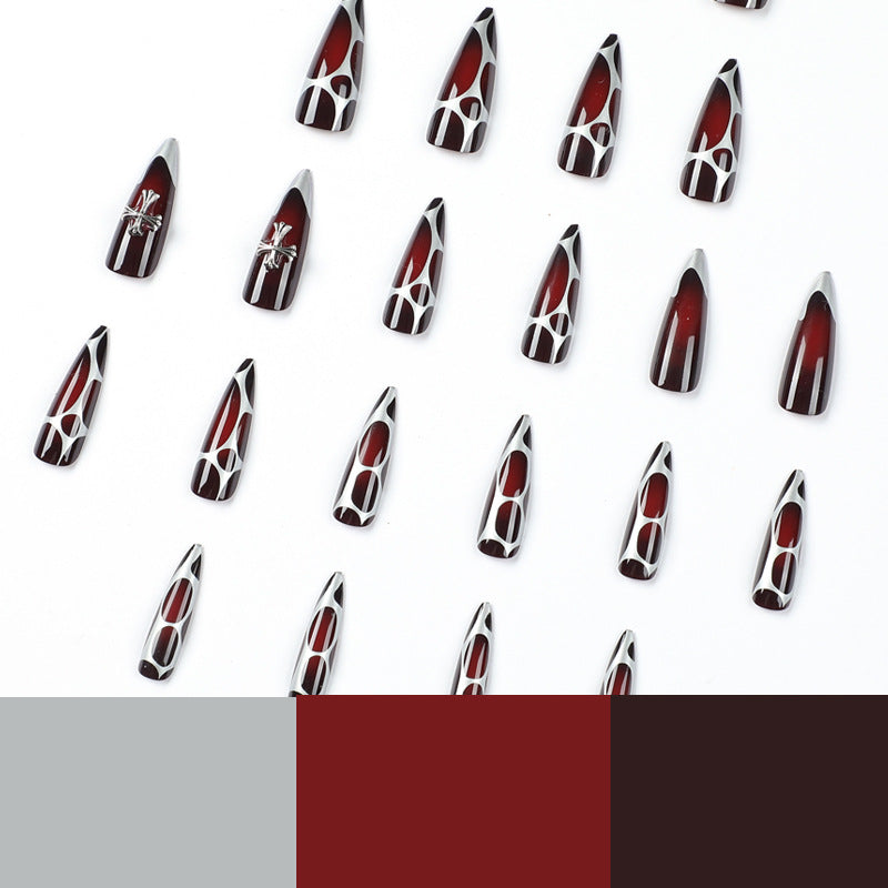 Kunstvolle Stiletto-Nägel mit eleganter Kreuzverzierung Karnz