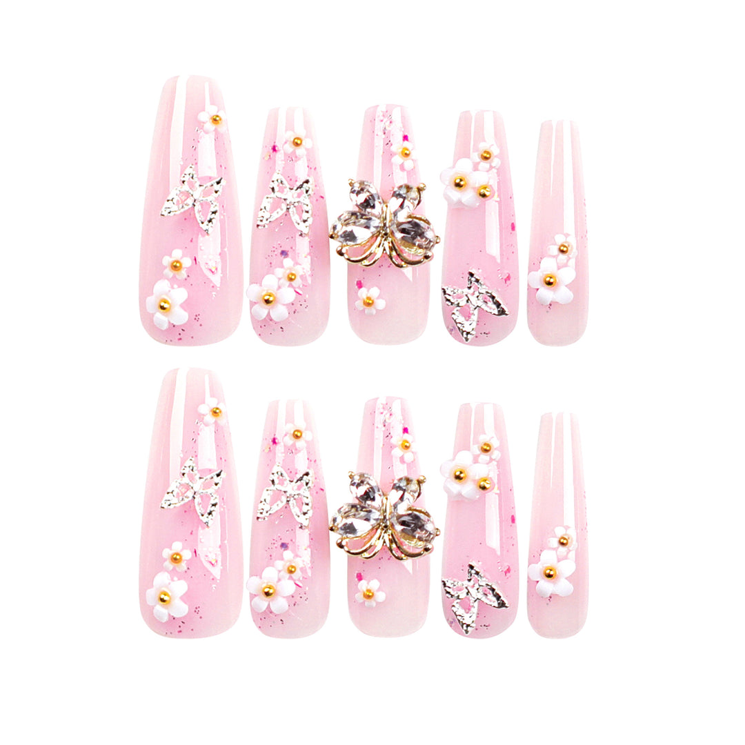 Kunstvolle Nagelverlängerungen mit Glitzer und floralen Akzenten Karnz
