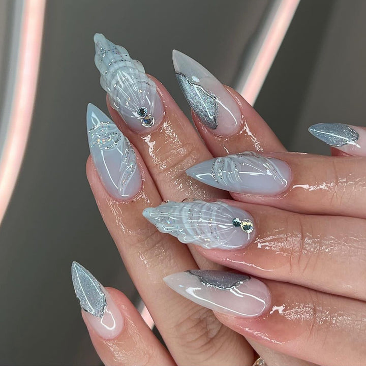 Kunstvolle Stiletto-Nägel mit eleganten Glitzer- und floralem Design Karnz