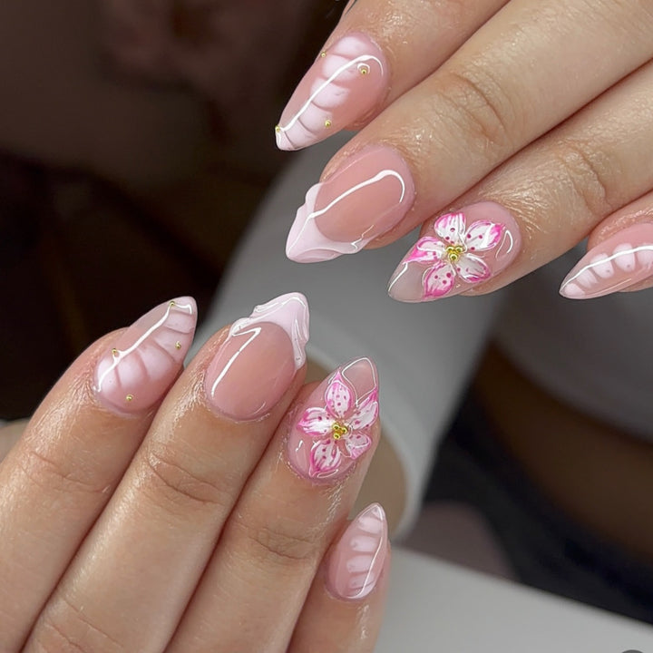 Kunstvolle Nagelverlängerungen mit floralem Design und Glitzerakzenten Karnz