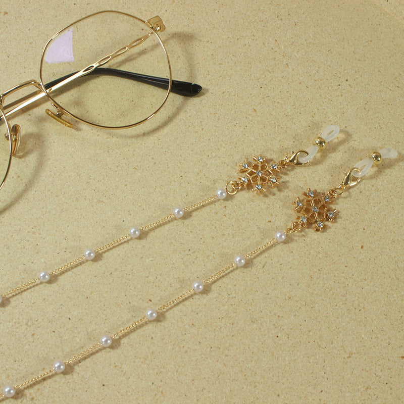 Elegante Brillenhalterkette mit Perlen und Schneeflockenanhänger Karnz