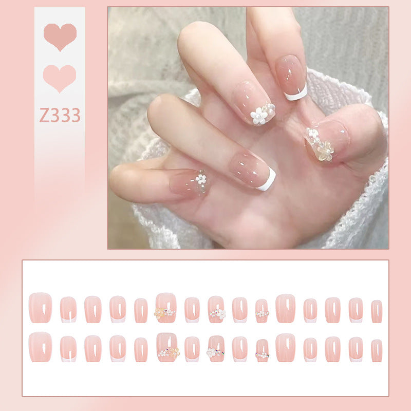 Kunstnagelset mit eleganten Blumenapplikationen und exquisite Glitzerverzierungen Karnz