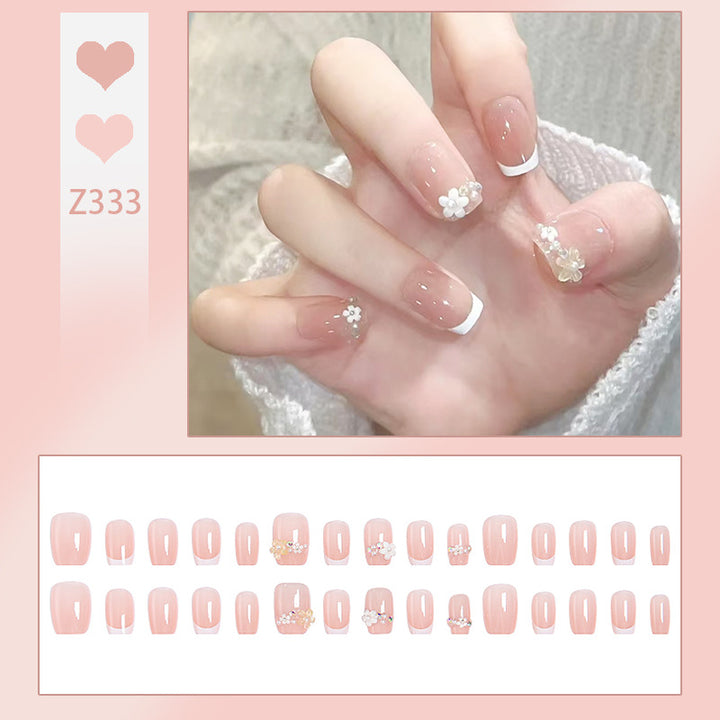 Kunstnagelset mit eleganten Blumenapplikationen und exquisite Glitzerverzierungen Karnz