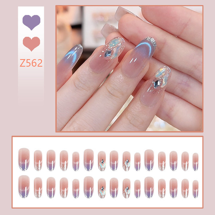 Kunstnagelset mit elegantem Glitzereffekt und verschönerten Applikationen Karnz