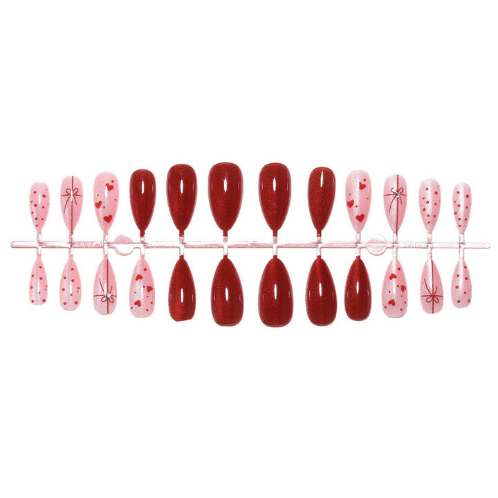 Dekoratives Press-On Nagelset mit Herz- und Schleifendesigns Karnz