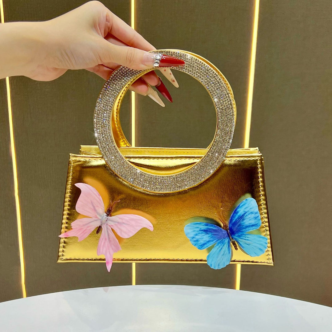 Künstlerische mit Schmetterlingen verzierte Handtasche