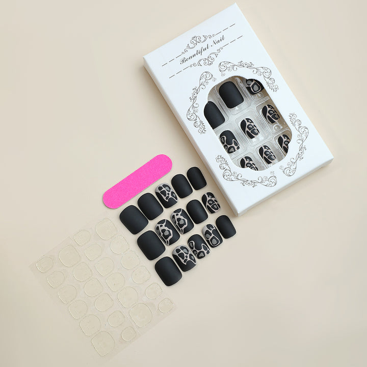 Künstlerisches Press-On Nagelset mit eleganten Designelementen Karnz