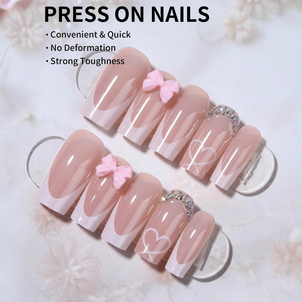 Kunstnagelset mit eleganten Schleifen- und Glitzerverzierungen Karnz