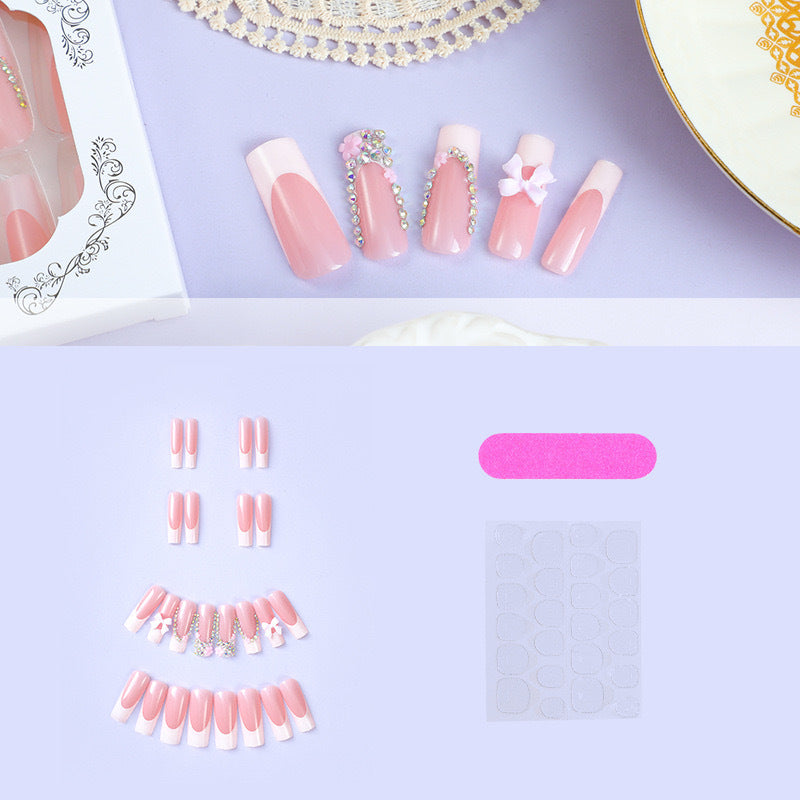 Kunstnagelset mit sorgfältigen Schleifen- und Glitzerverzierungen Karnz