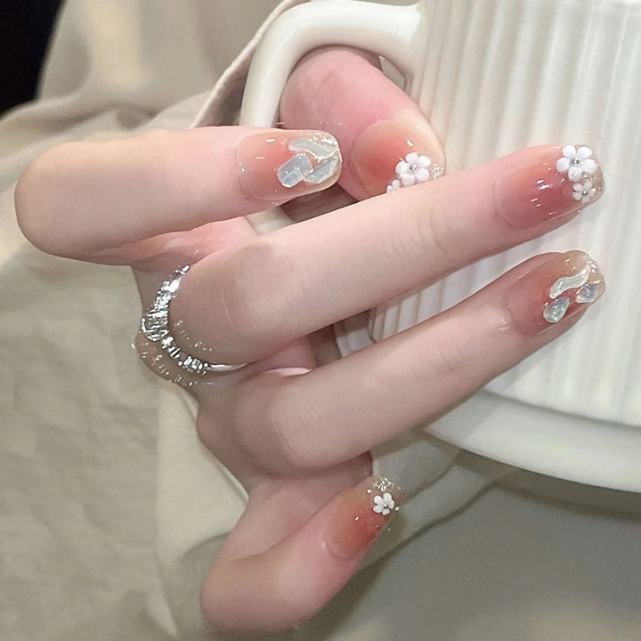 Kunstnagelset mit floralen 3D-Verzierungen und elegantem Glitzer Karnz