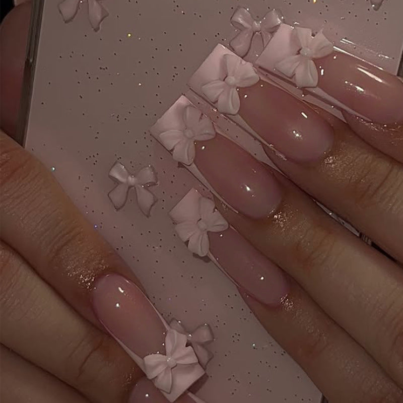 Kunstnagelset mit schimmernden Details und niedlichen Schleifen Karnz