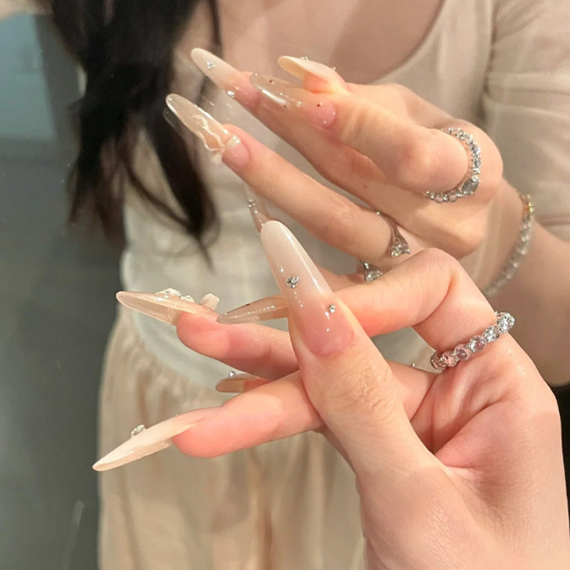 Elegante Stiletto Press-On Nägel mit dekorativem Bogen und Strassakzenten Karnz