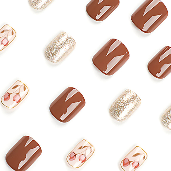 Künstliche Nail Art mit buntem Blumenmotiv und Glitzerakzenten Karnz