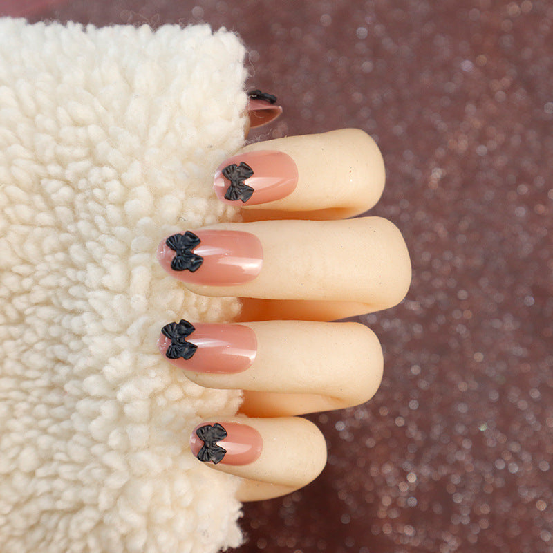 Dekorative Press-On Nagelset mit Schleifenakzenten