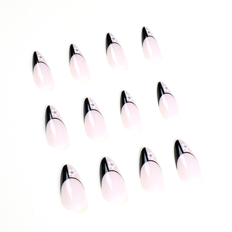 Kunstvolle Nagelkunst mit eleganten Schwarz-Weiß-Design und floralen Akzenten Karnz